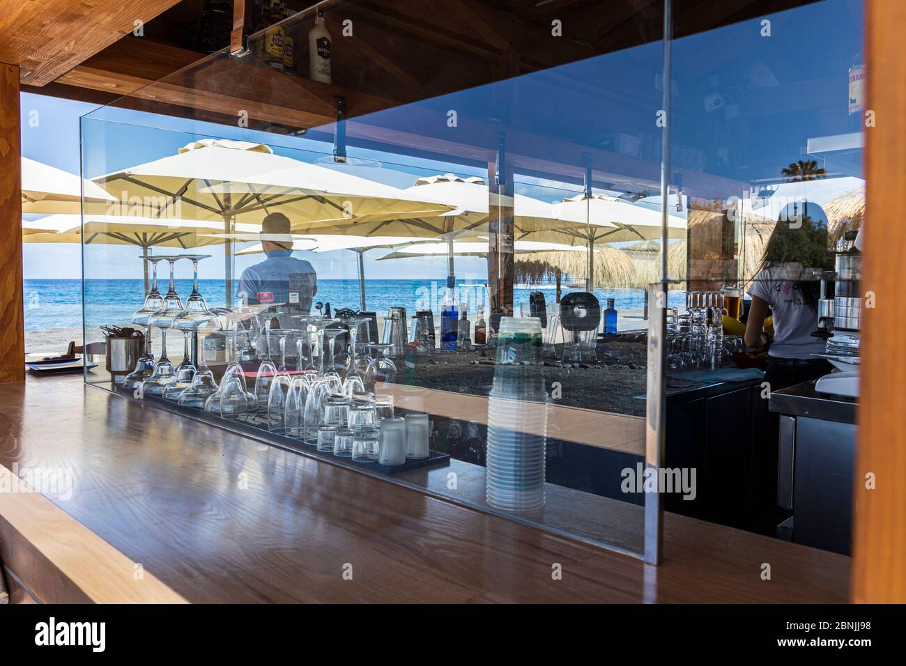Costa Adeje, Tenerife, Canary Islands, Spain. 15 May 2020. Preparing the Coqueluche beach bar, kiosk to open with limited facilities on Playa Enramada, La Caleta. New glass screens on the bar to protect staff and customers. Part of the de-escalation of the Covid 19, Coronavirus lockdown restrictions. Stock Photo