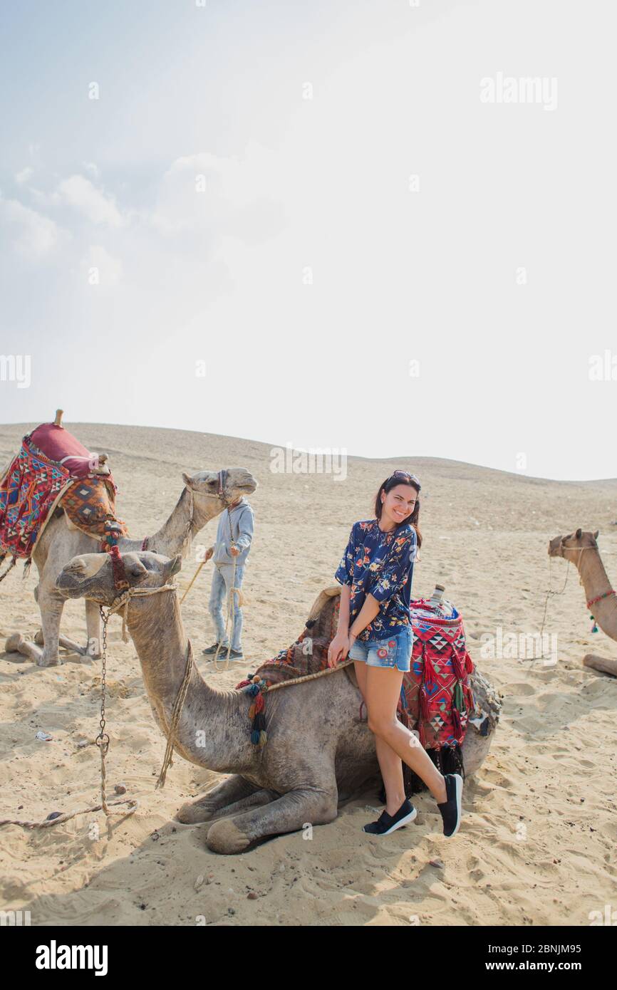 woman near camel in the Sahara desert Stock Photo
