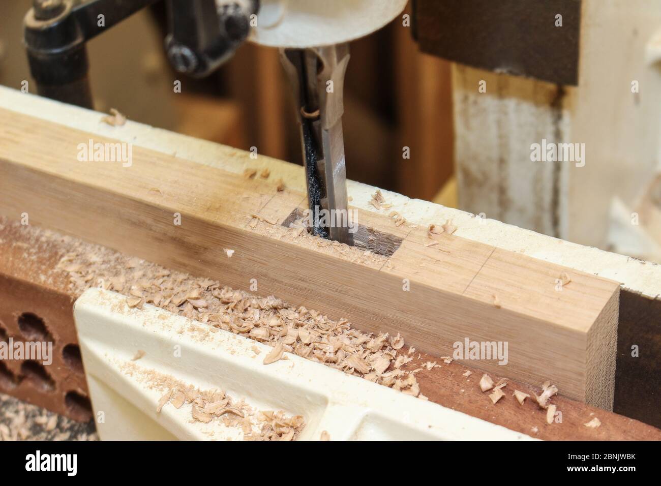 Cutting mortises in oak on a mortising machine oak mortise Stock
