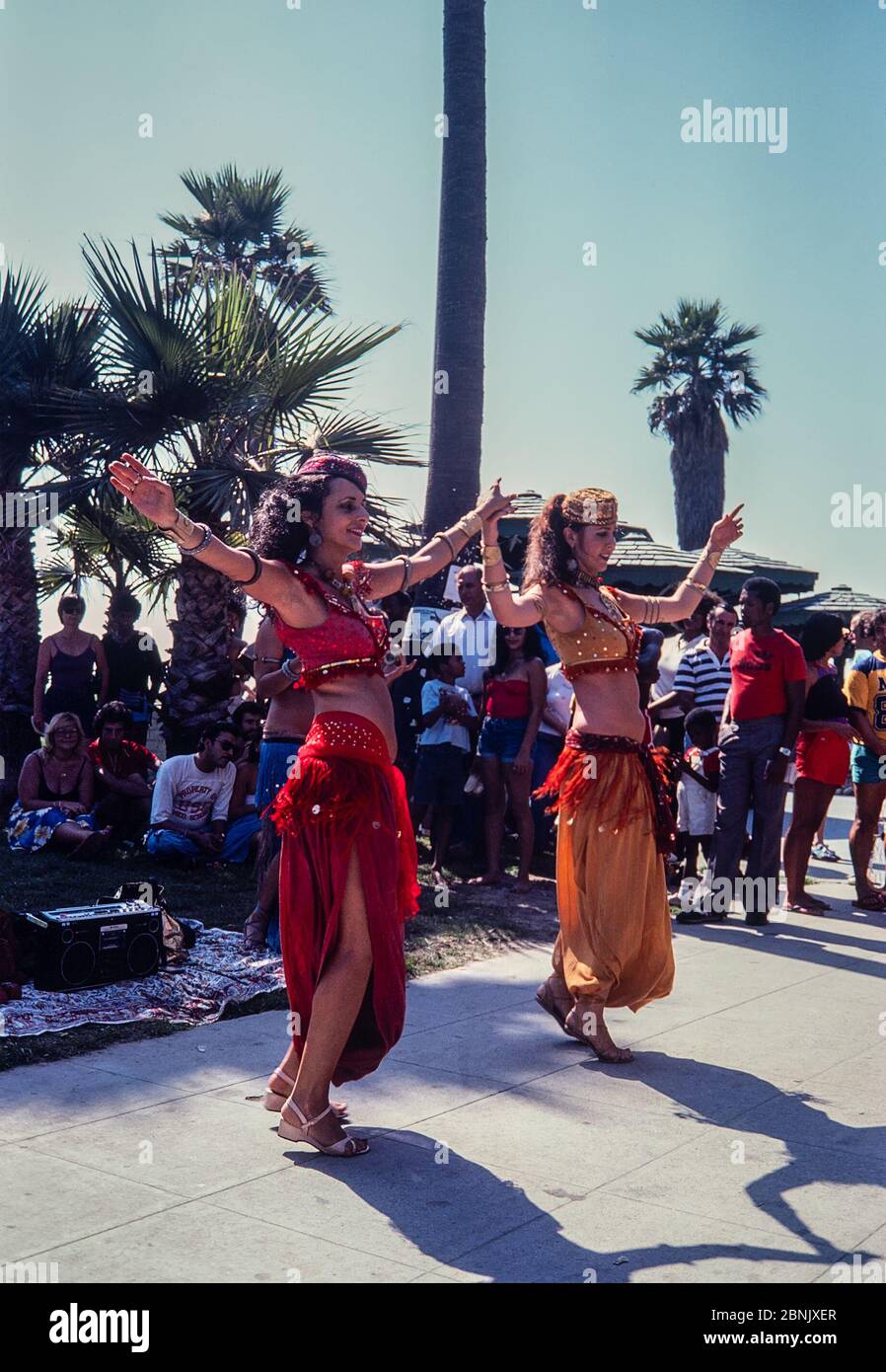 Venice, California, USA - Aug 1980: Belly dancers performing on the boardwalk at Venice Beach, Los Angeles, California.  Scanned 35mm film. Stock Photo