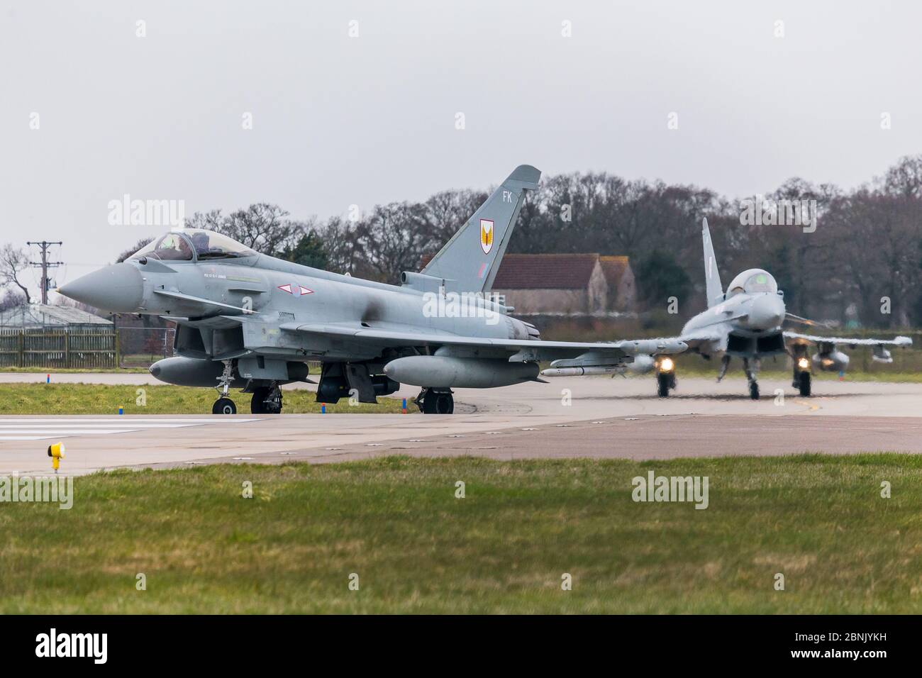 RAF Typhoon FGR4 duo taxiing to the runway at Conningsby in March 2016. Stock Photo