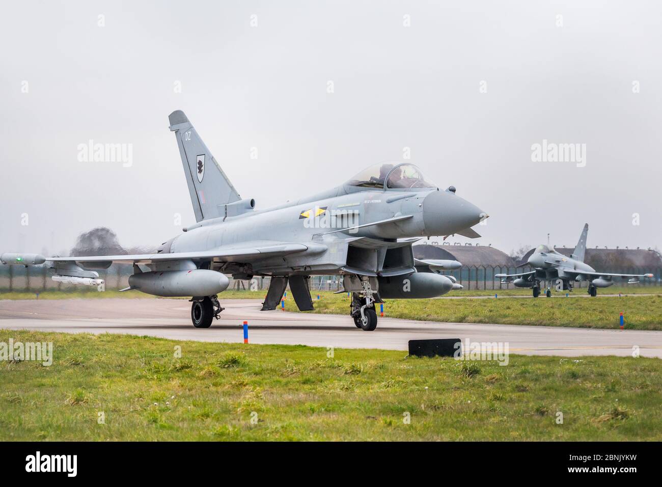 RAF Typhoon FGR4 pair moving out to the runway at Conningsby in March 2016. Stock Photo