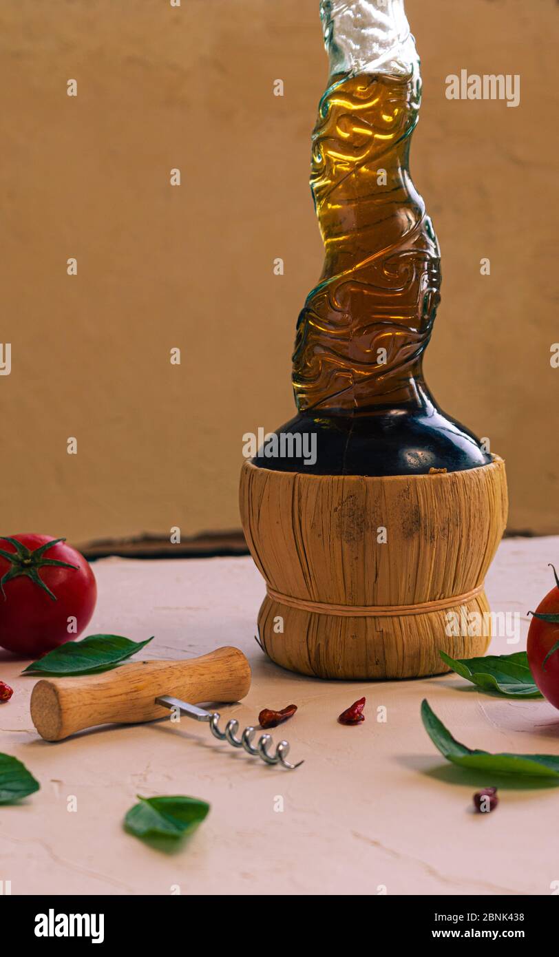 a bottle of italian moscato wine with opener and some food in a textured background Stock Photo
