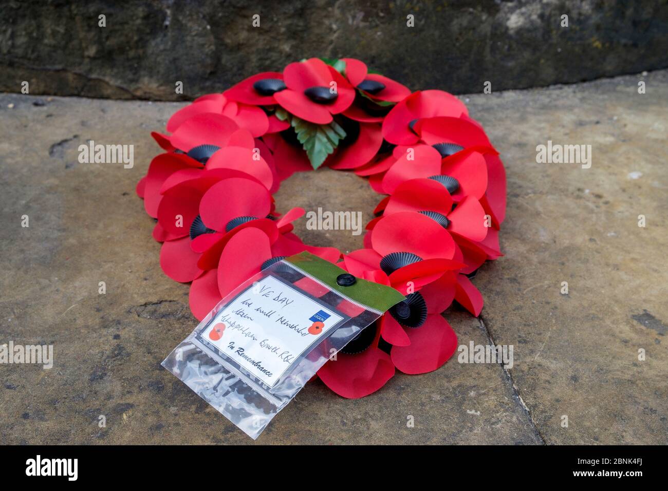 A poppy wreath is pictured at the war memorial in Chippenham, Wiltshire on the day the UK commemorates the 75th Anniversary of VE Day Stock Photo