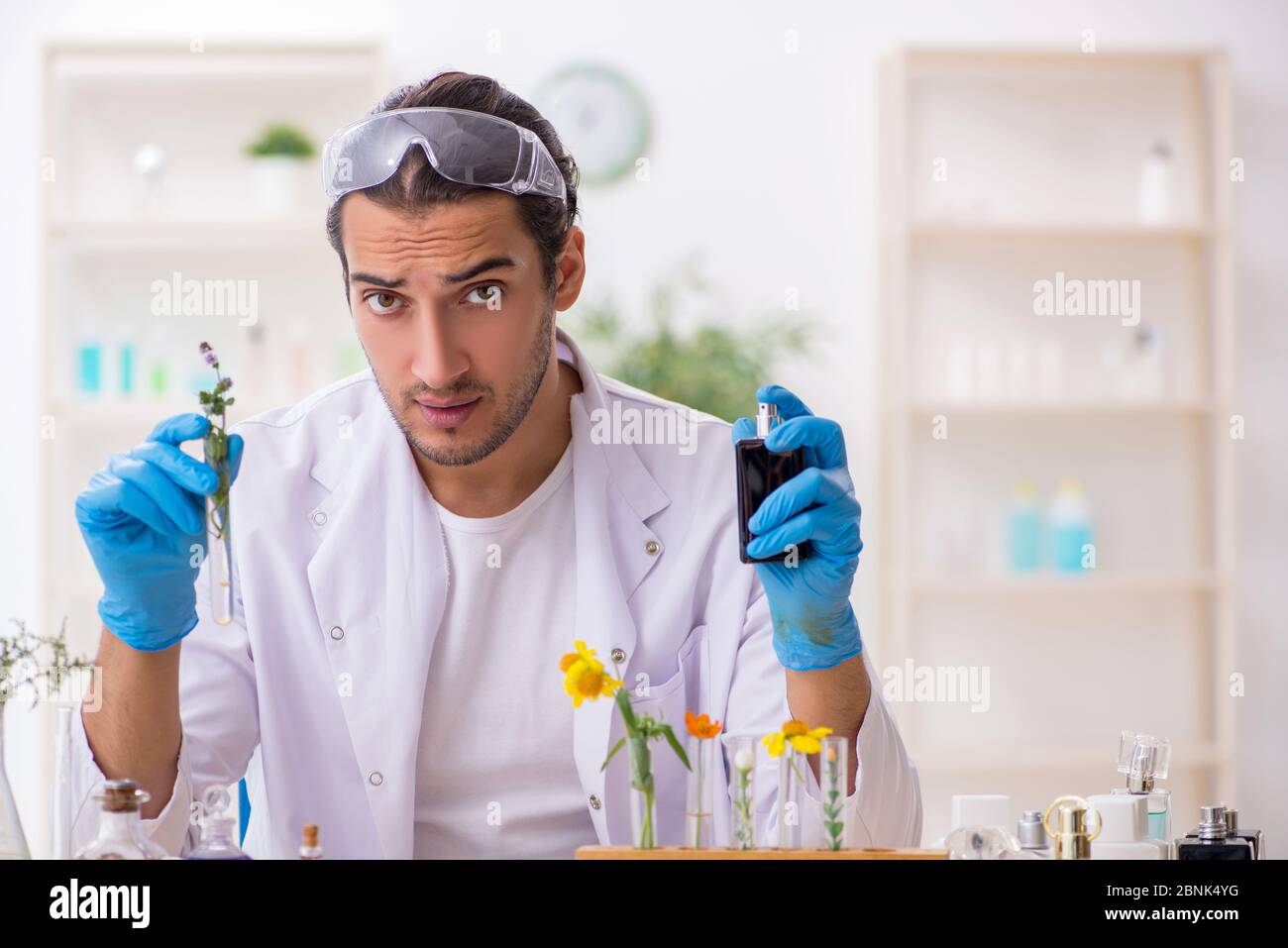 Young chemist in perfume synthesis concept Stock Photo Alamy