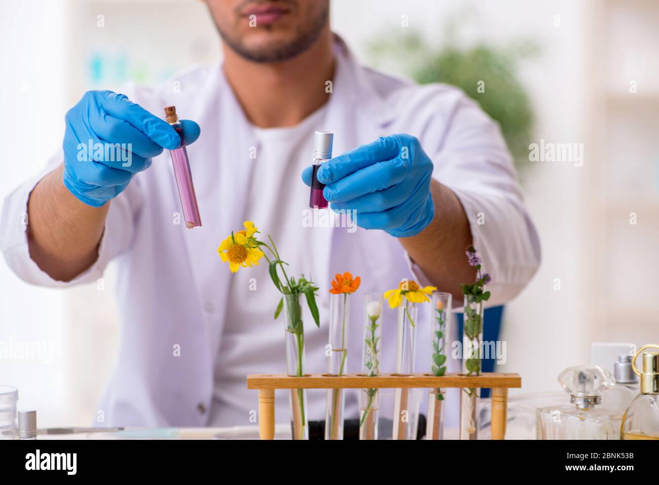 Young chemist in perfume synthesis concept Stock Photo Alamy