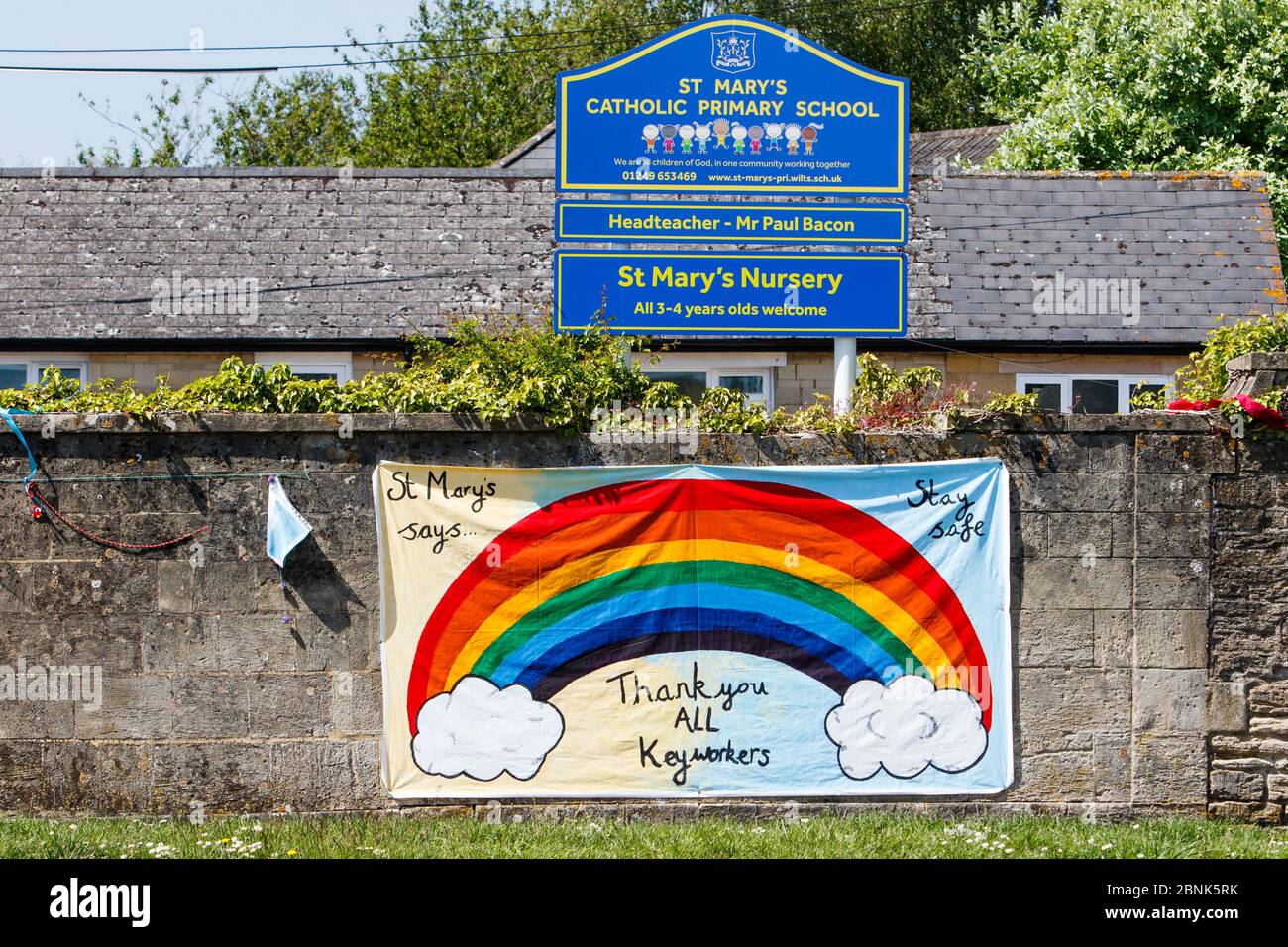 A 'thank you all key workers' rainbow sign that has been hung on a primary school wall is pictured opposite Chippenham Community Hospital, Wiltshire. Stock Photo