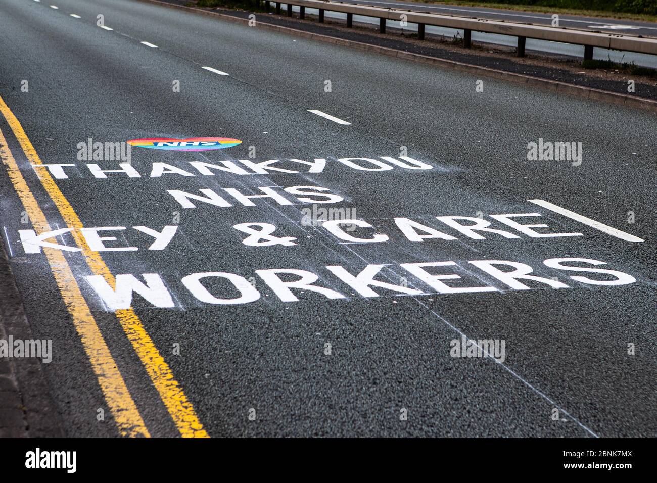 Dudley, West Midlands, UK. 15th May, 2020. A message of appreciation and thanks to the NHS, Key and Care Workers is painted on the surface of a busy dual carriageway on the approach to Russells Hall Hospital.The painted message has appeared overnight thanking the workers during the Covid-19 pandemic. Credit: Anthony Wallbank/Alamy Live News Stock Photo