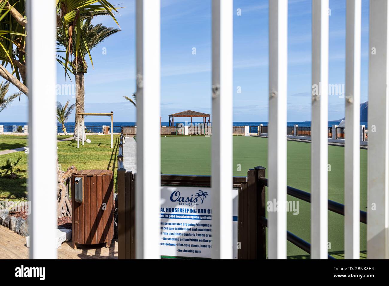 The Oasis bowling green and swimming pool deserted and closed during the Covid 19, Coronavirus lockdown, Los Gigantes, Tenerife, Canary Islands, Spain Stock Photo