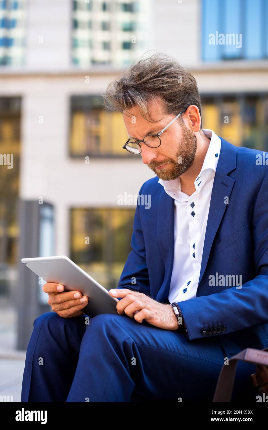 man working outside in Frankfurt Main, Germany Stock Photo