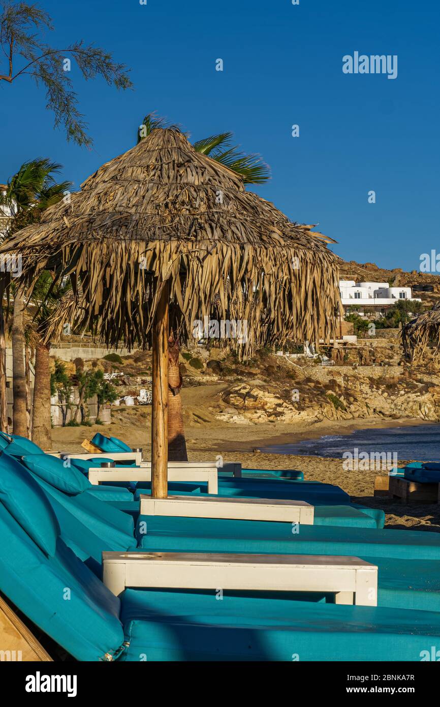 Empty luxurious wooden beach chairs mykonos paradise beach hires stock