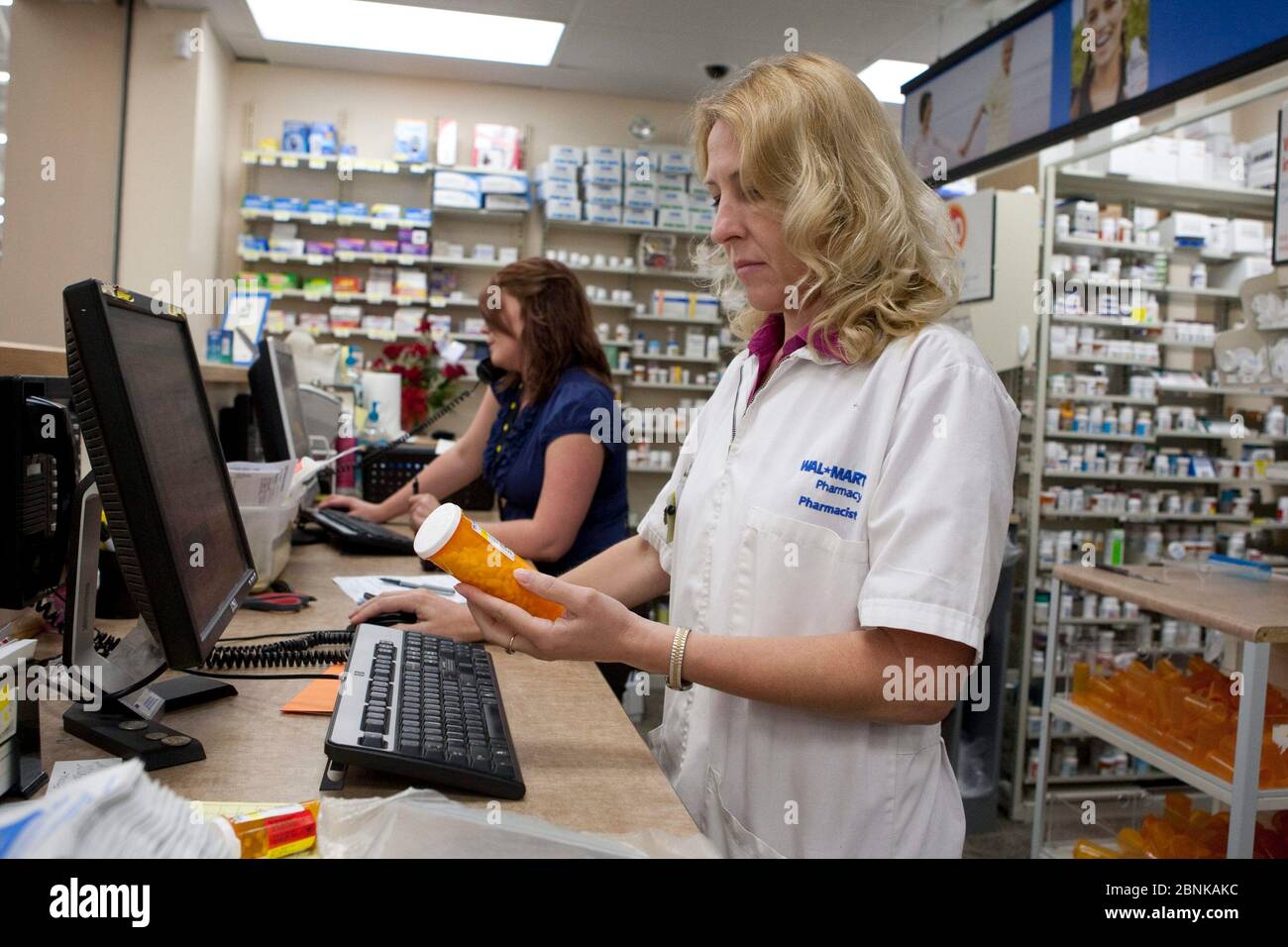 San Marcos, Texas USA, 2012: Female white Pharmacist and pharmacy tech working at Wal-Mart Supercenter pharmacy. ©Marjorie Kamys Cotera/Daemmrich Photography Stock Photo