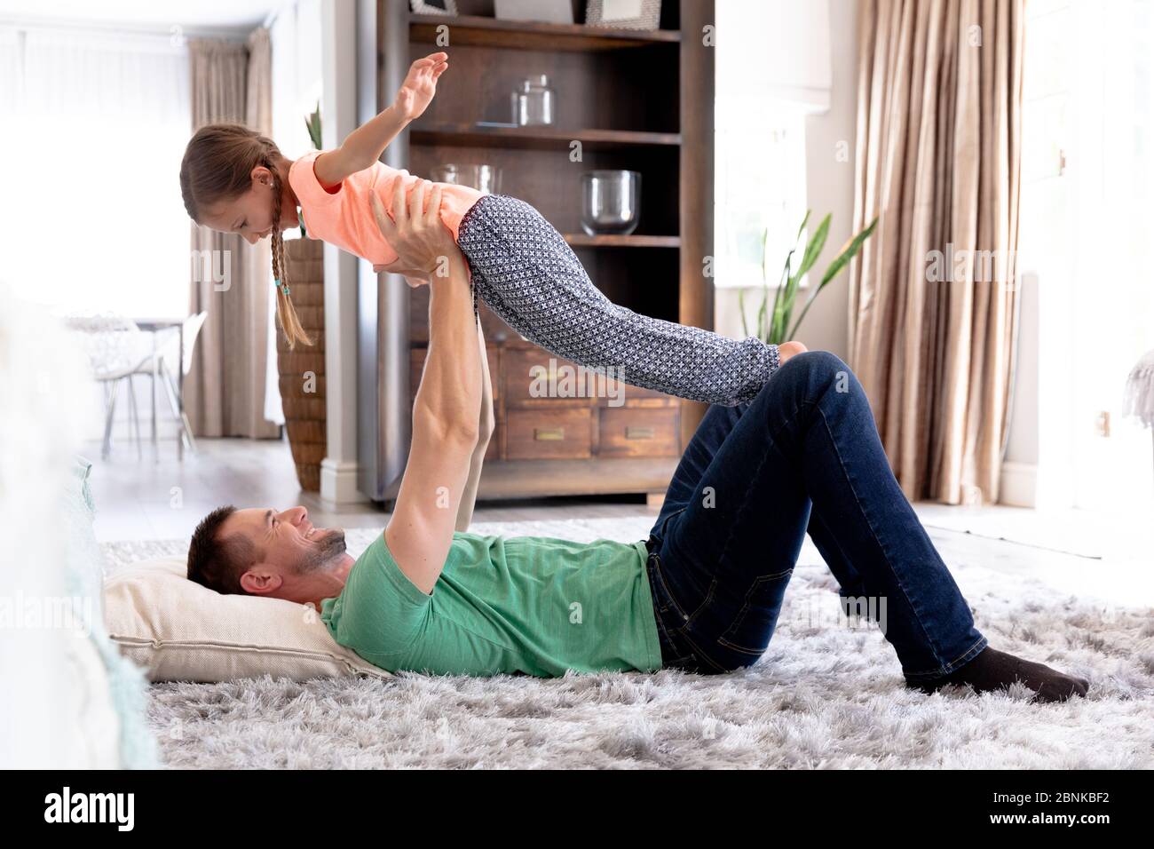 Caucasian girl and her dad spending time together at home Stock Photo