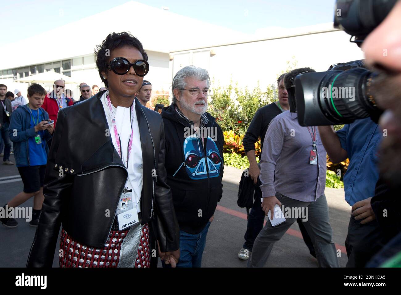 Austin Texas USA, November 18, 2012: Director and  filmmaker George Lucas (c) with girlfriend Mellody Hudson (l) in the celebrity-packed paddock area at the Circuit of the Americas race track prior to the inaugural Formula One United States Grand Prix. ©Bob Daemmrich Stock Photo