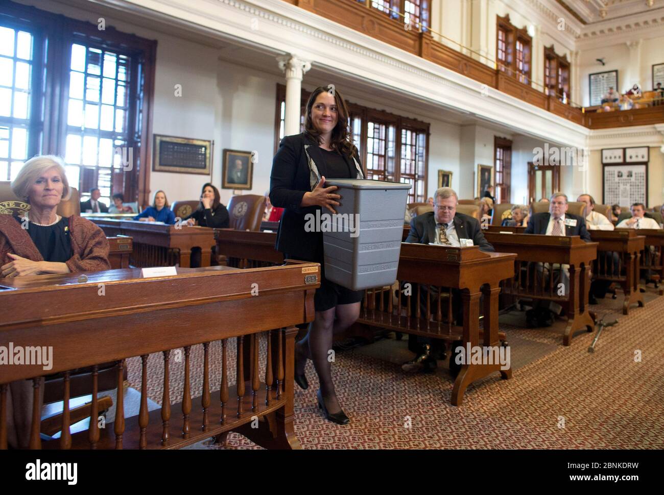 Austin Texas USA, December 17, 2012: A Texas Secretary of State worker carries the ballot box as Texas Republican members of the Electoral College vote for the presidential ticket of Mitt Romney/Paul Ryan during ceremonies Monday at the Texas Capitol. As expected the candidates scored a unanimous victory and results were forwarded to Washington, D.C. as required by the U.S. Constitution. ©Bob Daemmrich Stock Photo