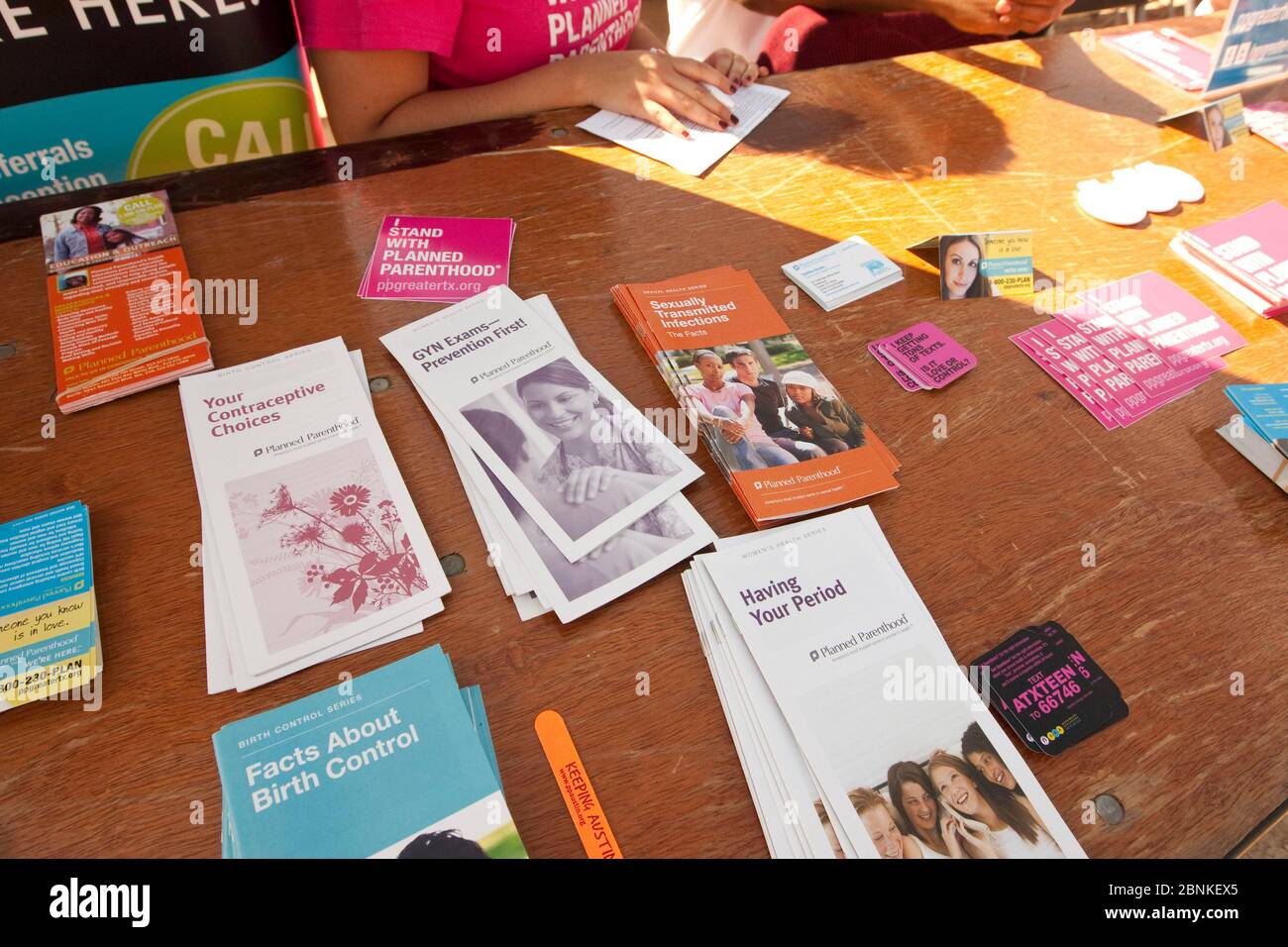 Austin Texas USA, January 21, 2013: Brochures promote various women's health services provided by Planned Parenthood on an information table at an outdoor festival at a small college. Stock Photo