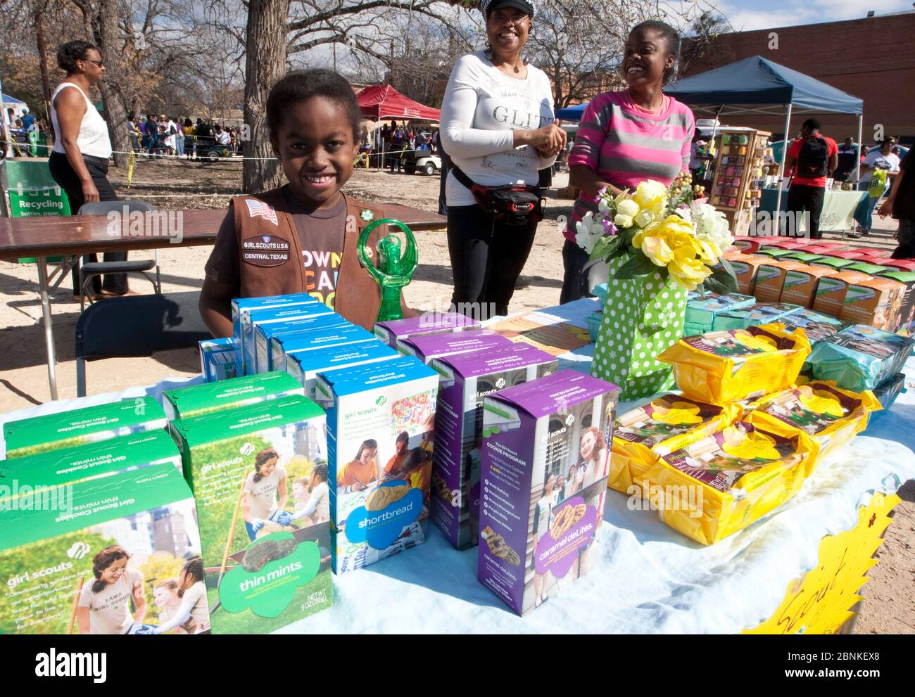 Austin Texas USA, January 21, 2013: Young Black Girl Scout sets up her Girl Scout cookies for sale at an outdoor festival at small college campus on the Martin Luther King Jr. birthday holiday. Stock Photo
