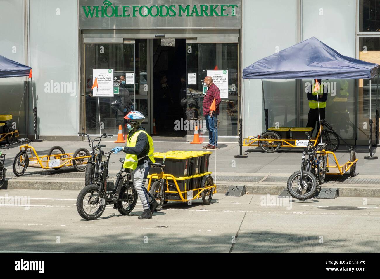 Whole Foods Market employs Carla Cargo trailer with e-bike for food delivery in Midtown Manhattan during the COVID-19 pandemic, New York City, USA Stock Photo