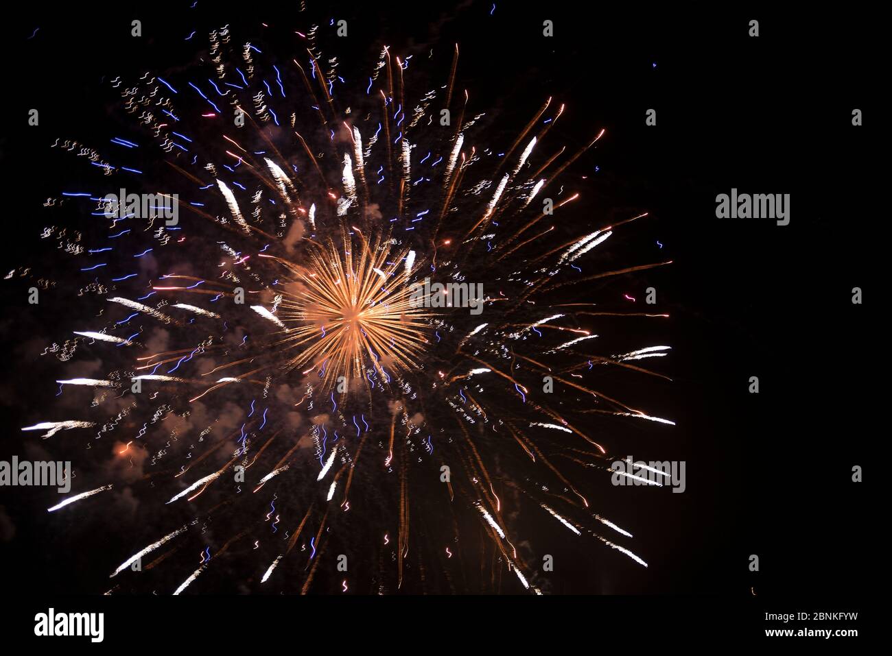 Colorful fireworks over dark sky, displayed during a celebration Stock Photo