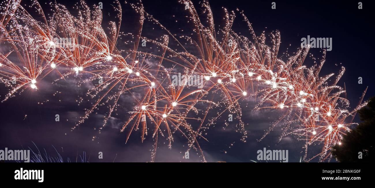 Colorful fireworks over dark sky, displayed during a celebration Stock Photo