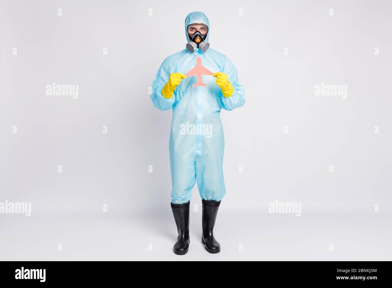 Full length photo of man hold paper card plane no travel covid19