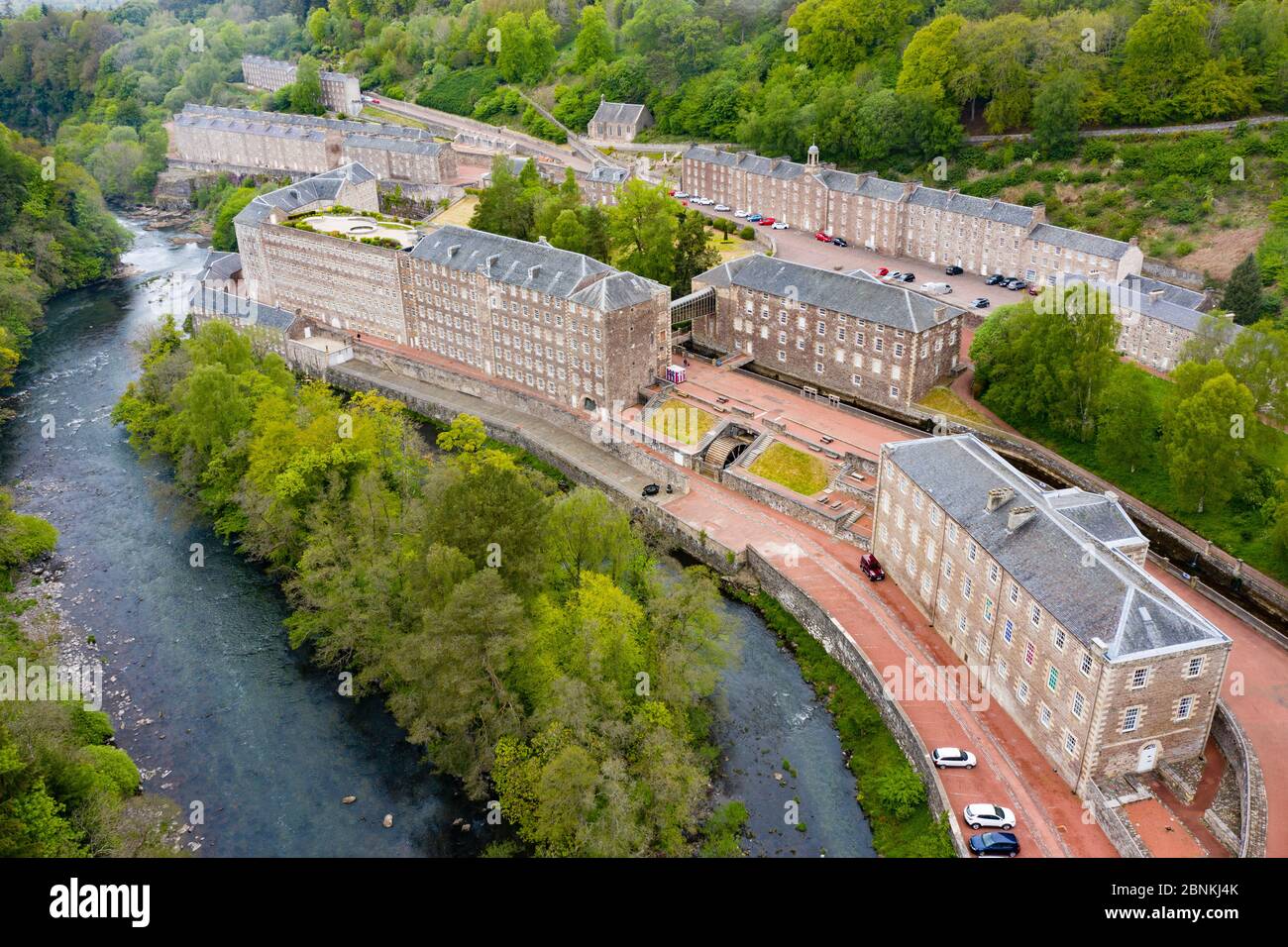 Aerial view of New Lanark World Heritage Site closed during covid-19 lockdown, beside River Clyde in South Lanarkshire, Scotland, UK Stock Photo