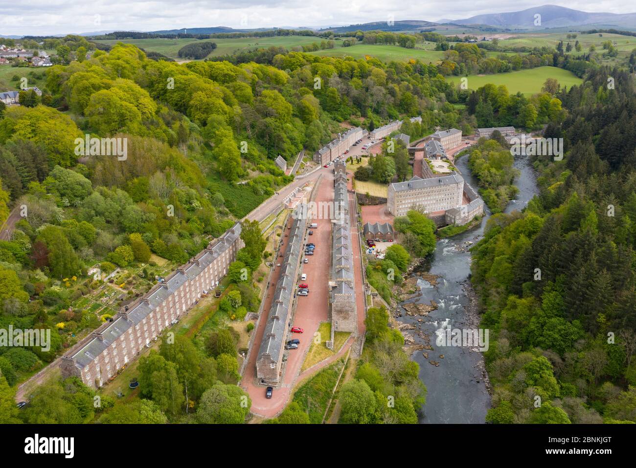 Aerial view of New Lanark World Heritage Site closed during covid-19 lockdown, beside River Clyde in South Lanarkshire, Scotland, UK Stock Photo