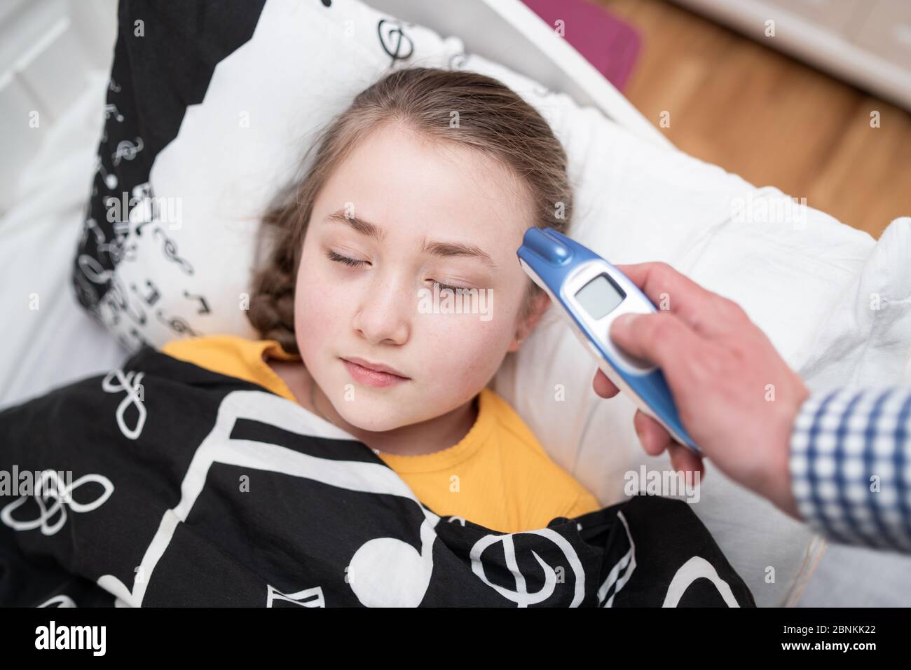 Measuring temperature. Ill caucasian child and her father with