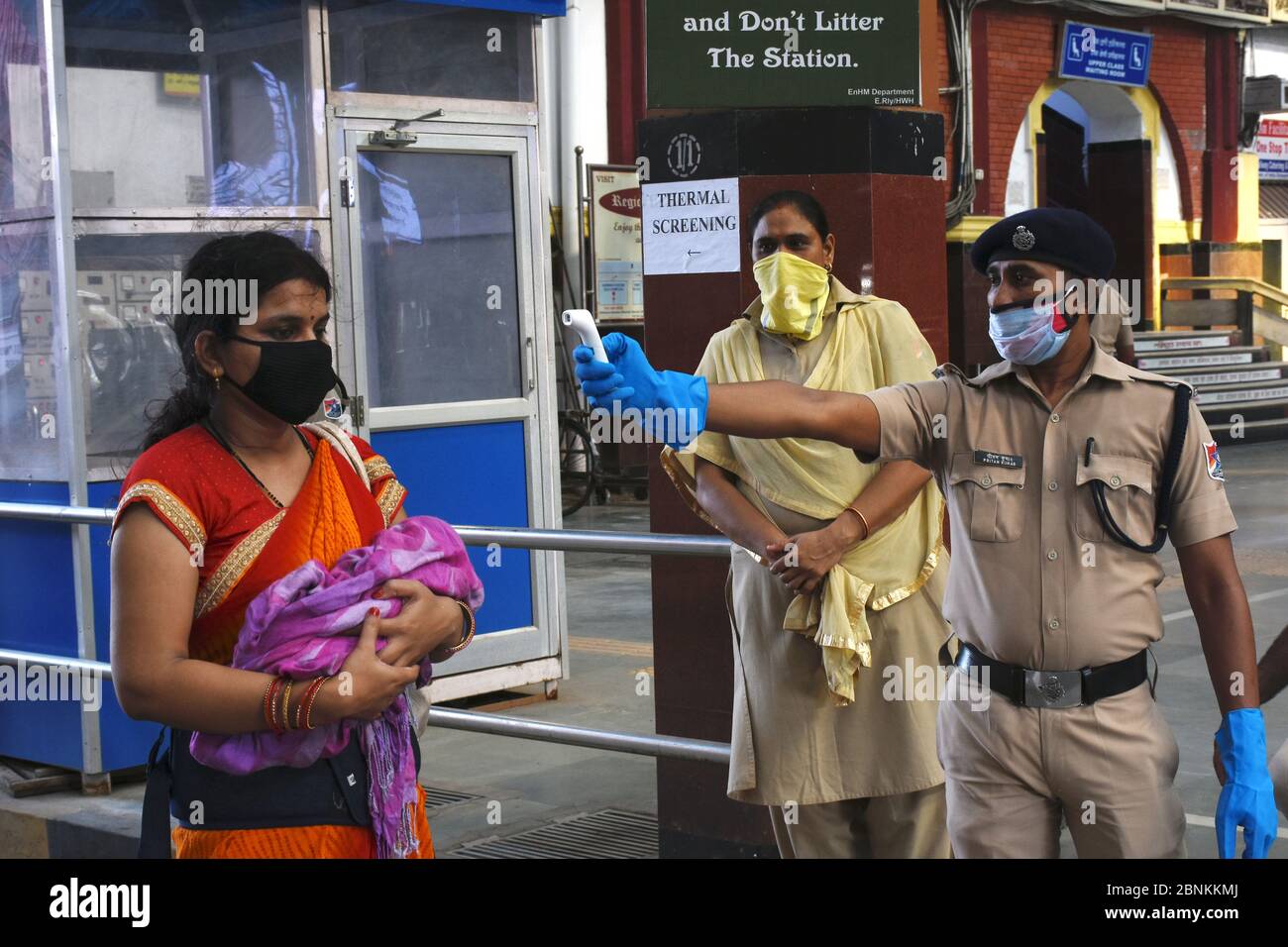 Howrah, India. 15th May, 2020. Railway Police examine the body temperature by thermal screening before entering the Howrah Station. (Photo by Suraranjan Nandi/Pacific Press) Credit: Pacific Press Agency/Alamy Live News Stock Photo