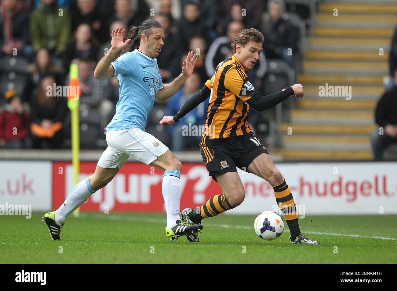 KINGSTON UPON HULL, ENGLAND - Nico Jelavic of Hull City and Martin Demichelis of Manchester City during the Premier League match between Hull City and Manchester City at the KC Stadium, Kingston upon Hull on Saturday 15th March 2014 (Credit: Mark Fletcher | MI News) Stock Photo