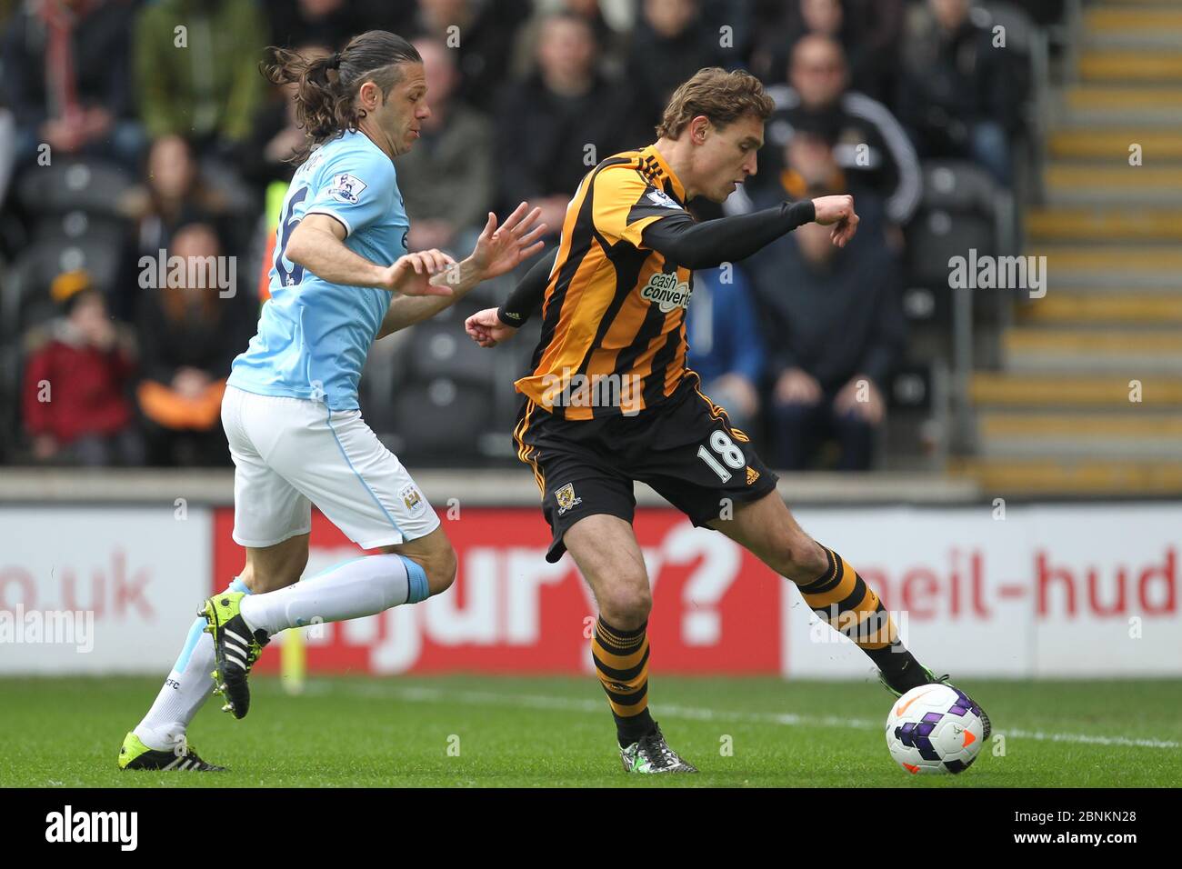 KINGSTON UPON HULL, ENGLAND - Nico Jelavic of Hull City and Martin Demichelis of Manchester City during the Premier League match between Hull City and Manchester City at the KC Stadium, Kingston upon Hull on Saturday 15th March 2014 (Credit: Mark Fletcher | MI News) Stock Photo