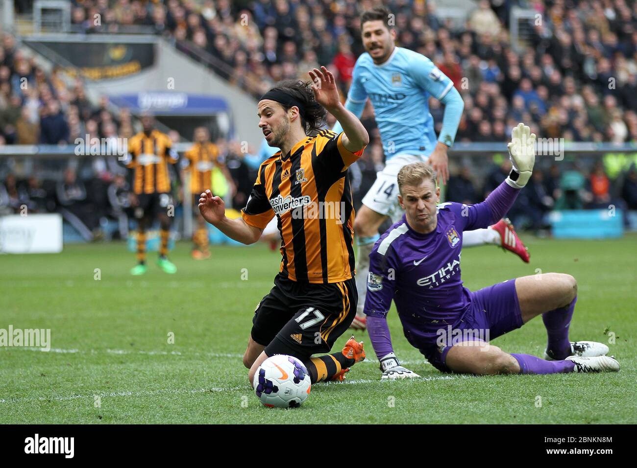 KINGSTON UPON HULL, ENGLAND - George Boyd of Hull City goes down in the penalty area after a Joe Hart challenge during the Premier League match between Hull City and Manchester City at the KC Stadium, Kingston upon Hull on Saturday 15th March 2014 (Credit: Mark Fletcher | MI News) Stock Photo
