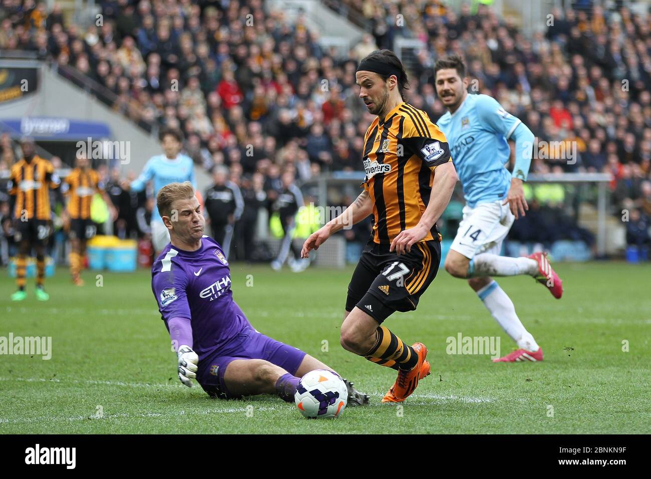 KINGSTON UPON HULL, ENGLAND - George Boyd of Hull City goes down in the penalty area after a Joe Hart challenge during the Premier League match between Hull City and Manchester City at the KC Stadium, Kingston upon Hull on Saturday 15th March 2014 (Credit: Mark Fletcher | MI News) Stock Photo