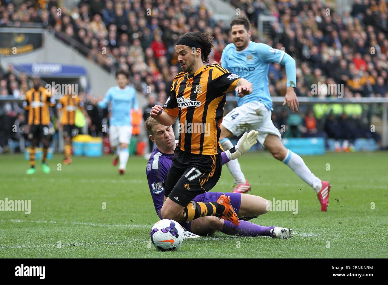 KINGSTON UPON HULL, ENGLAND - George Boyd of Hull City goes down in the penalty area after a Joe Hart challenge during the Premier League match between Hull City and Manchester City at the KC Stadium, Kingston upon Hull on Saturday 15th March 2014 (Credit: Mark Fletcher | MI News) Stock Photo