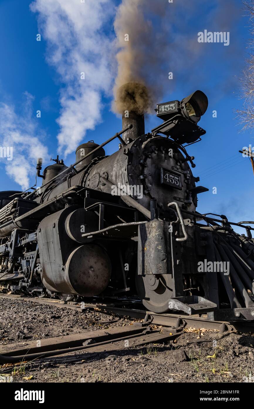 Steam locomotive building steam for work hauling passengers, at the Chama Station of the Cumbres & Toltec Scenic Railroad in Chama, New Mexico, USA Stock Photo