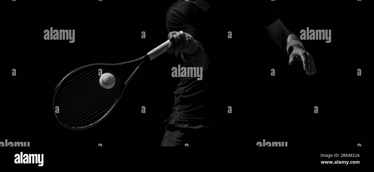 Male tennis player in action on the court on a sunny day. Black and ...