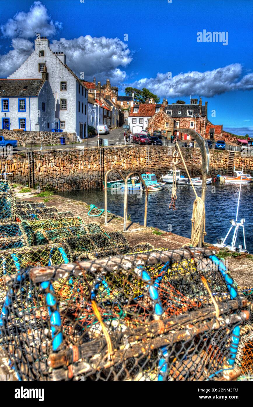Town of Crail, Scotland. Artistic view of Crail cobbled harbour with lobster pots in the foreground, and harbour residences in the background. Stock Photo