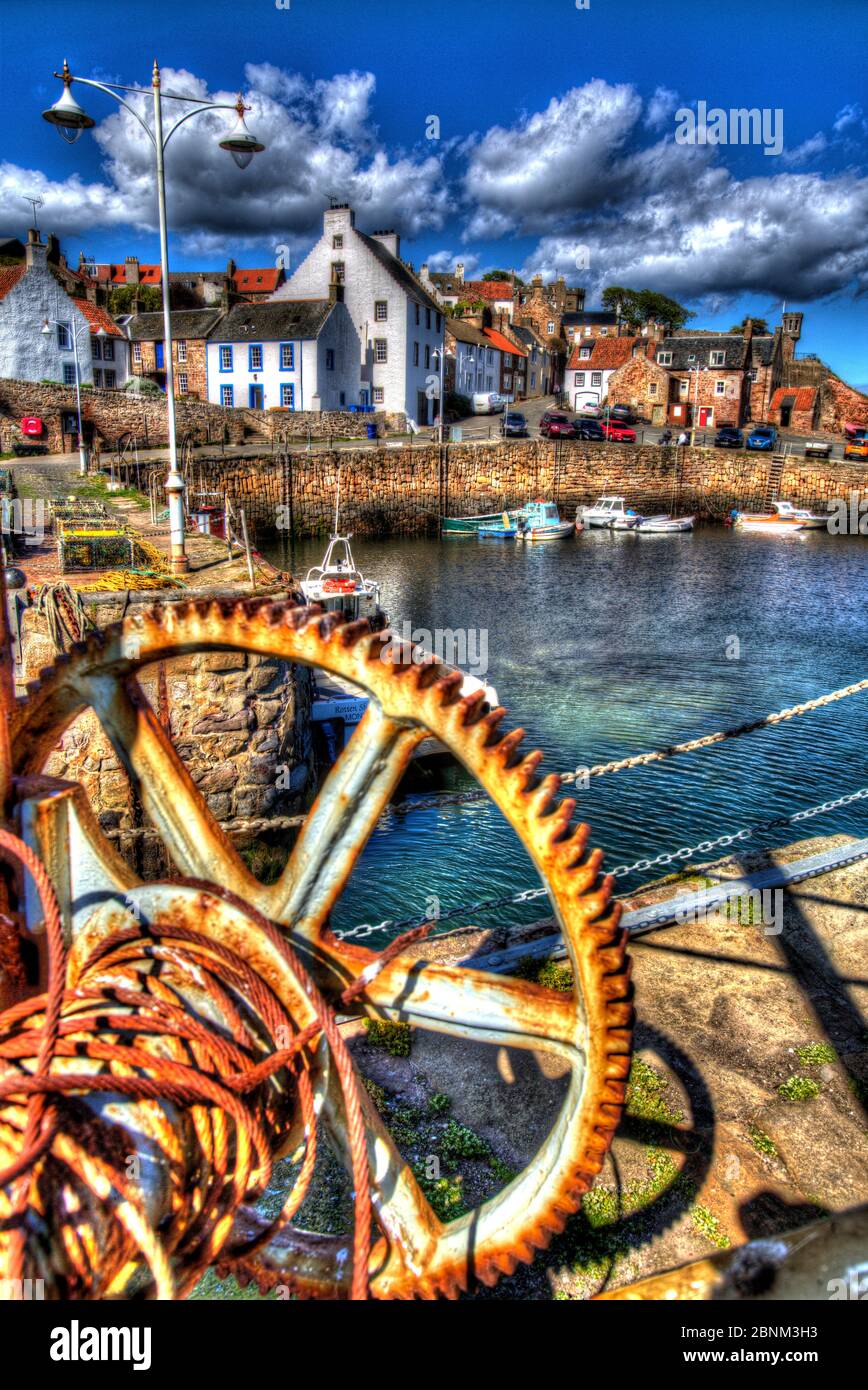 Town of Crail, Scotland. Artistic sunny view of rusted lifting gear on Crail harbour wall. Stock Photo
