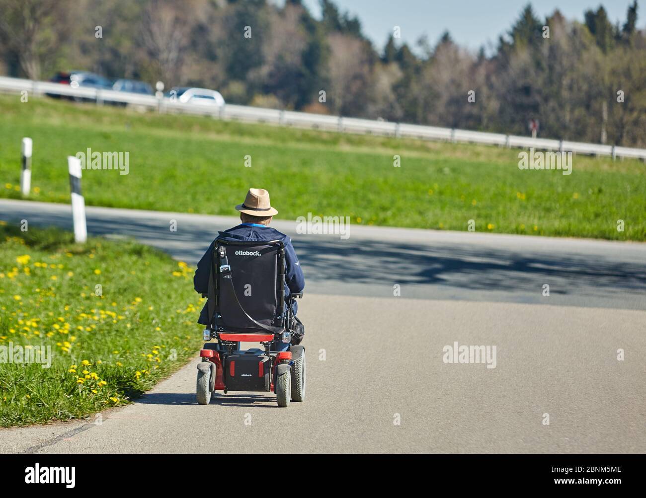 Wheelchair users, main road, country road, spring, green meadows Stock Photo