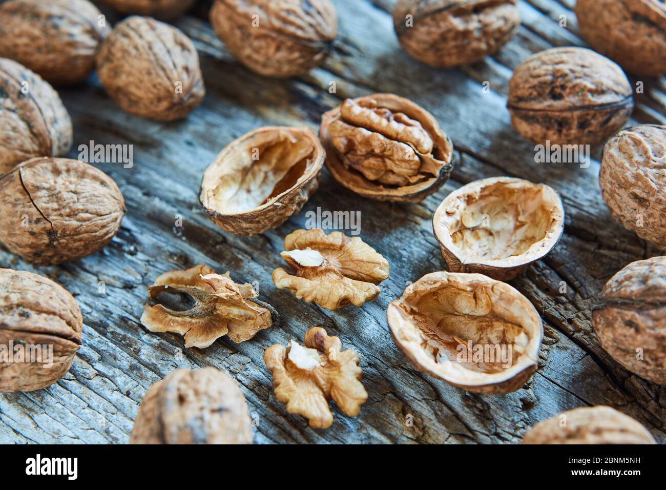 Walnuts, closed, open, supervision, wooden board Stock Photo