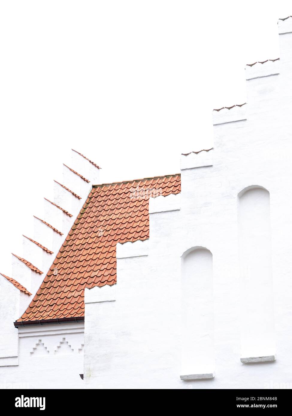 High key shot of a Danish church with a stepped gable. Stock Photo