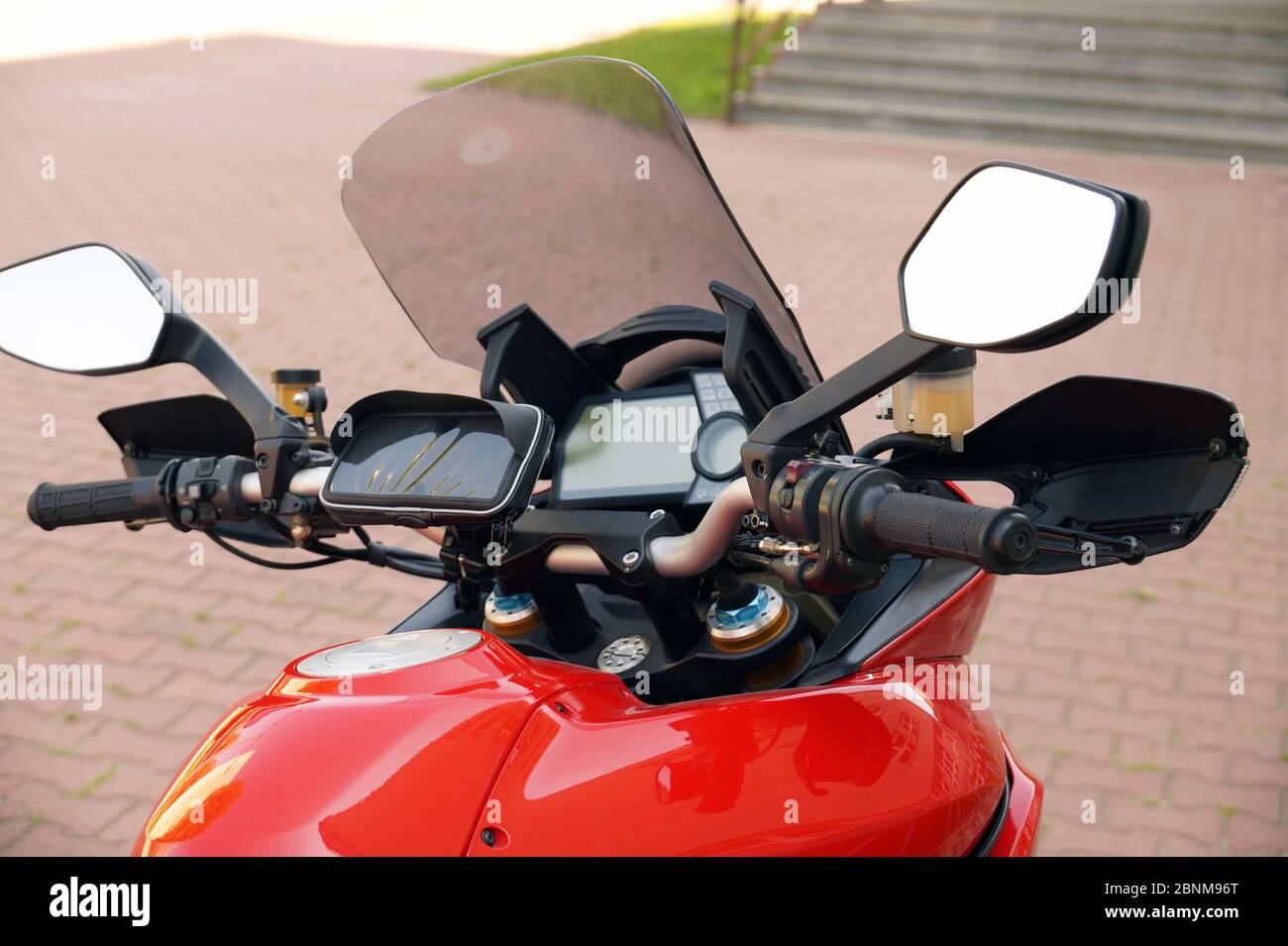 Before the trip. Motorcycle steering wheel with fairing and a case for a mobile phone. Stock Photo