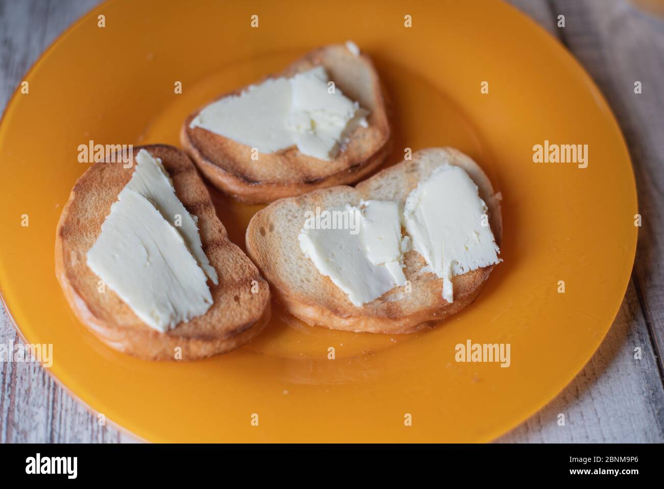 Fried slice of toast with butter top view. Fried bread with butter