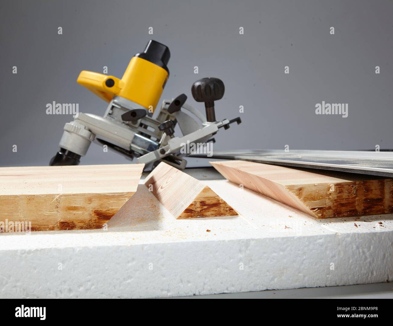 Construction of a shelf made of wood, do-it-yourself production, step-by-step, step 3b cross-sections with a circular saw, 45 degree miter cut with guide rail, styrofoam base Stock Photo