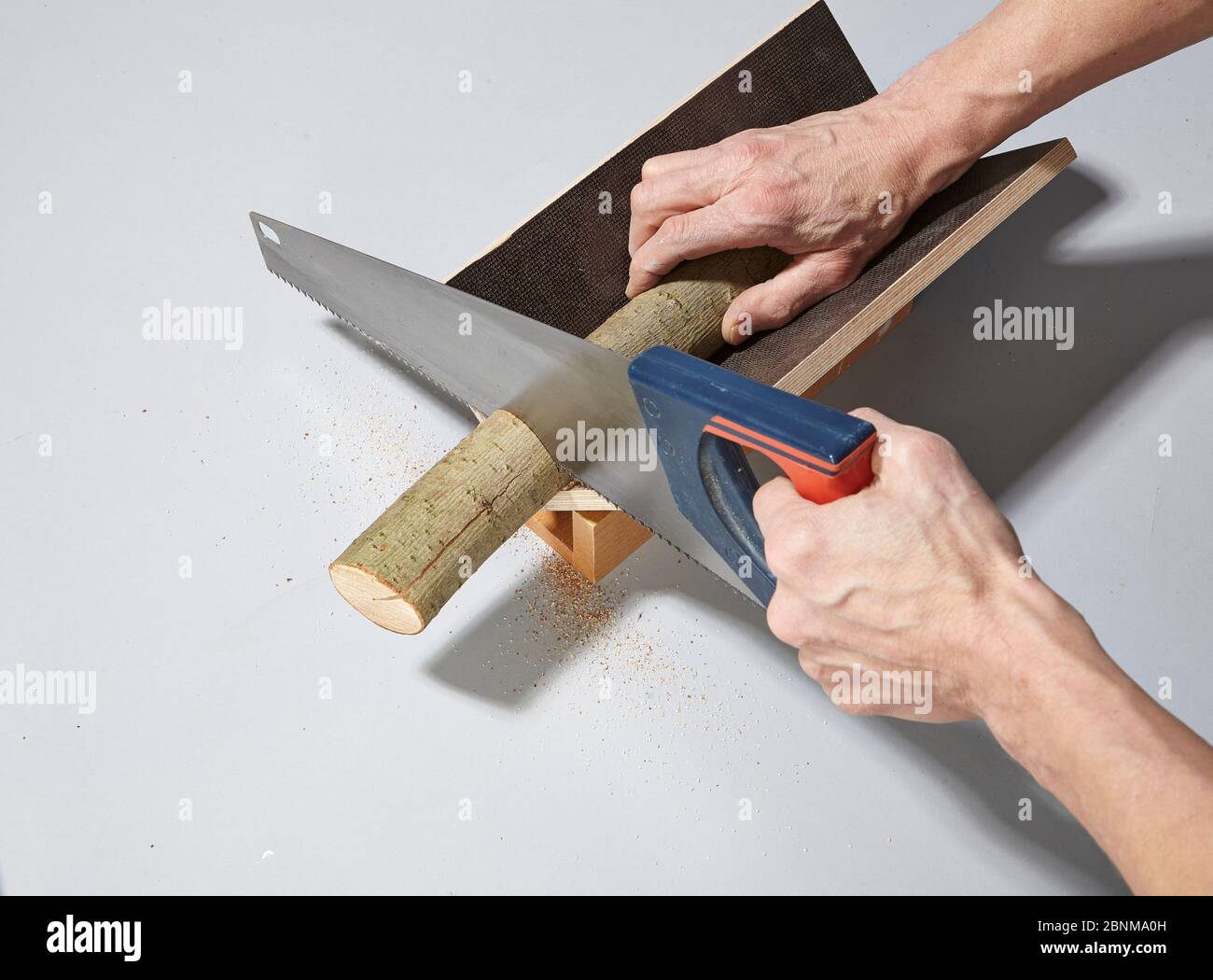 Construction of a shelf made of wood, do-it-yourself production,  step-by-step, step 10 Cutting the branch with the help of a self-made saw  drawer, which is as long as the branch to be