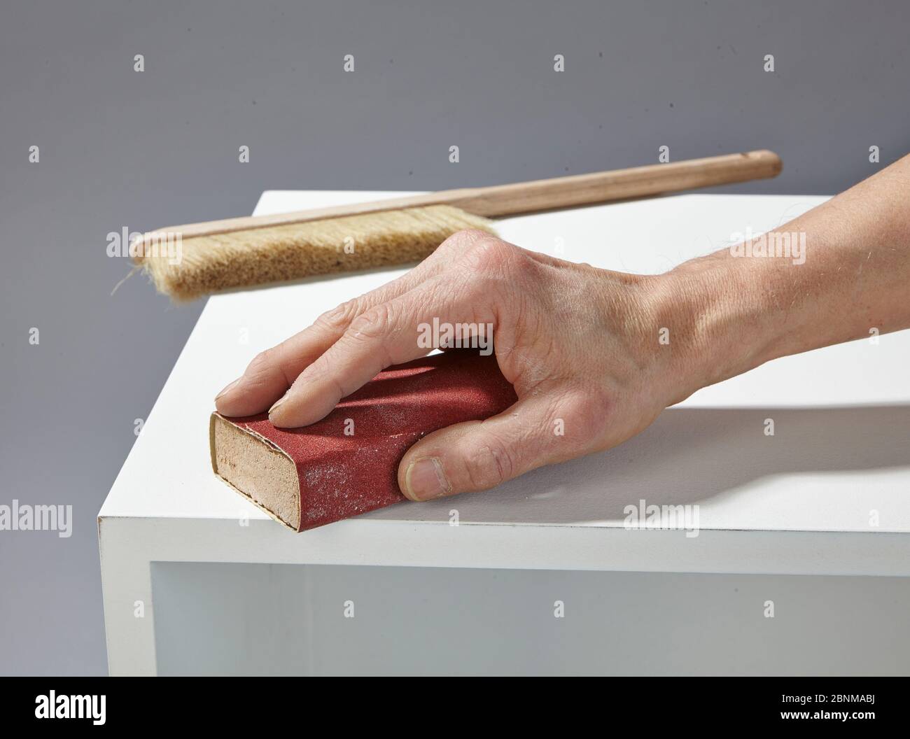 Construction of a shelf made of wood, Euro pallet, solid wood, MDF board; Do-it-yourself production, step-by-step, step 13b intermediate sanding with sanding block, then dedusting again Stock Photo