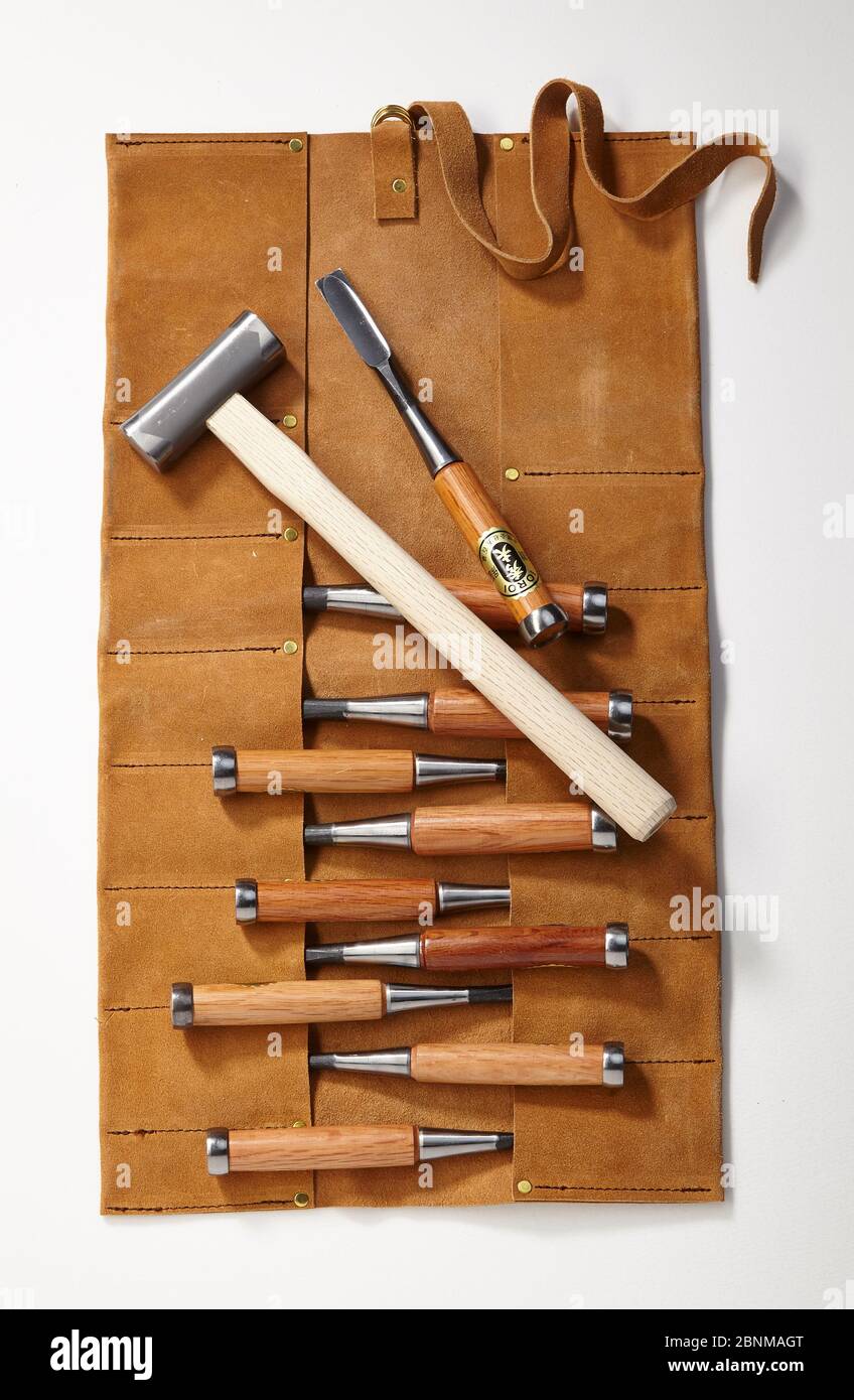 a set of wood chisels with a leather roller pocket and hammer, photo on white, series of tools for working wood from Japan, Japanese tool for woodworking Stock Photo