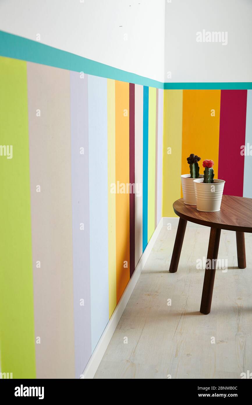 DIY wall design 01, step-by-step do-it-yourself production, vertical colored stripes in the lower wall area, final photo 04 in the living room with decoration Stock Photo