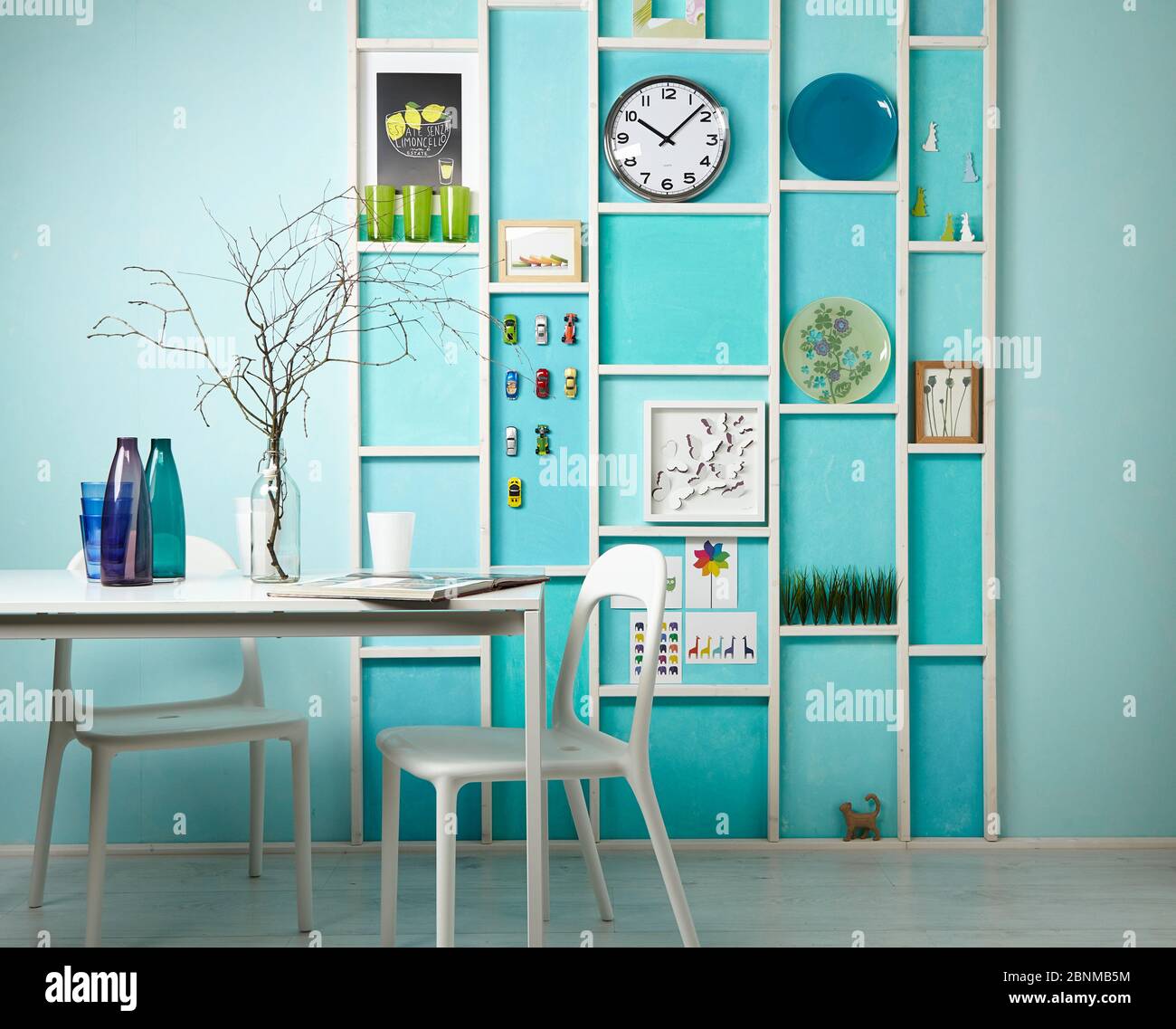 DIY wall design 02, step-by-step do-it-yourself production, various turquoise colored areas separated by white wooden strips, final photo 01 in the living room with decoration Stock Photo