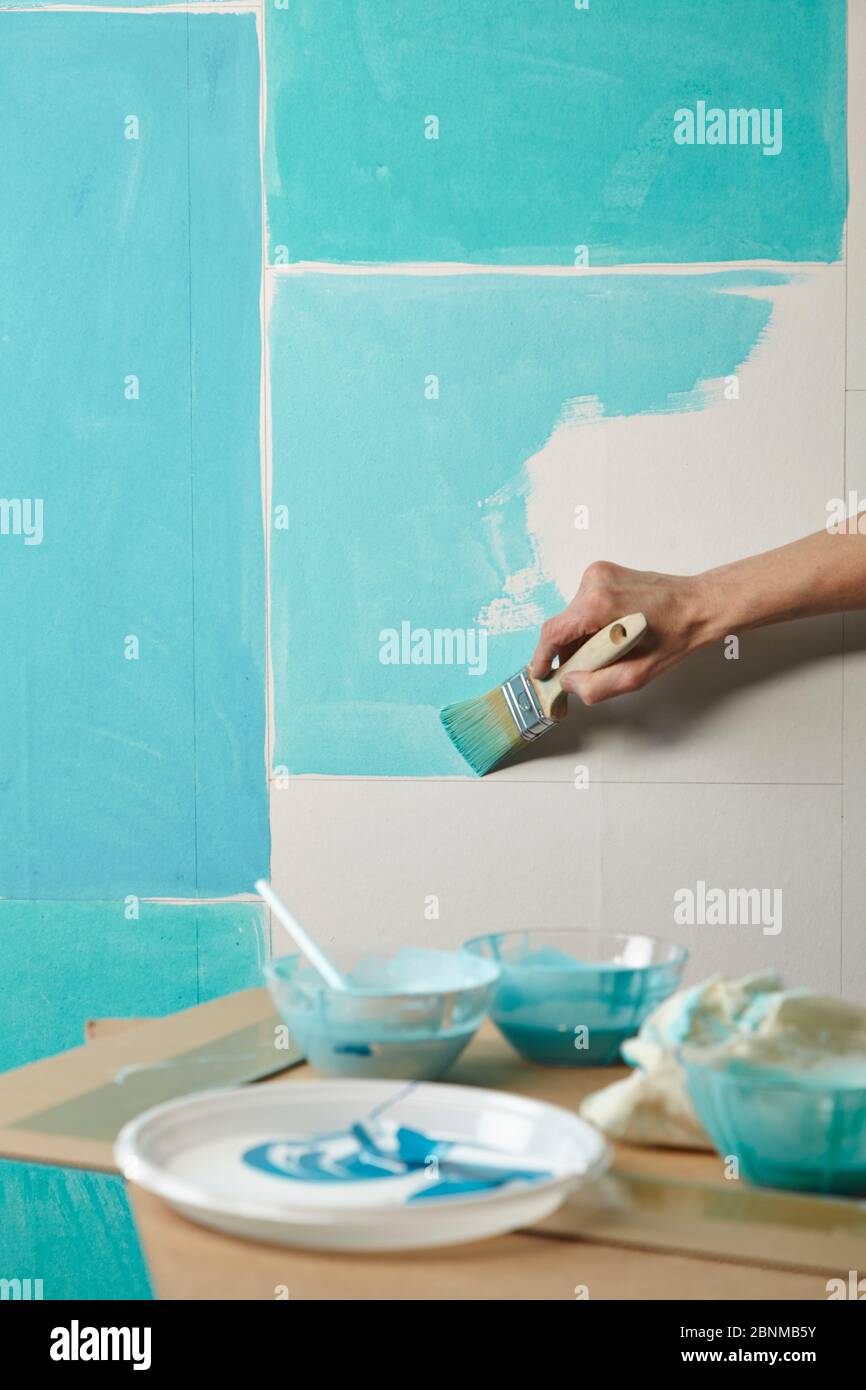 DIY wall design 02, step-by-step do-it-yourself production, various turquoise colored areas separated by white wooden strips, step 03c: paint the individual areas with different turquoise tones Stock Photo